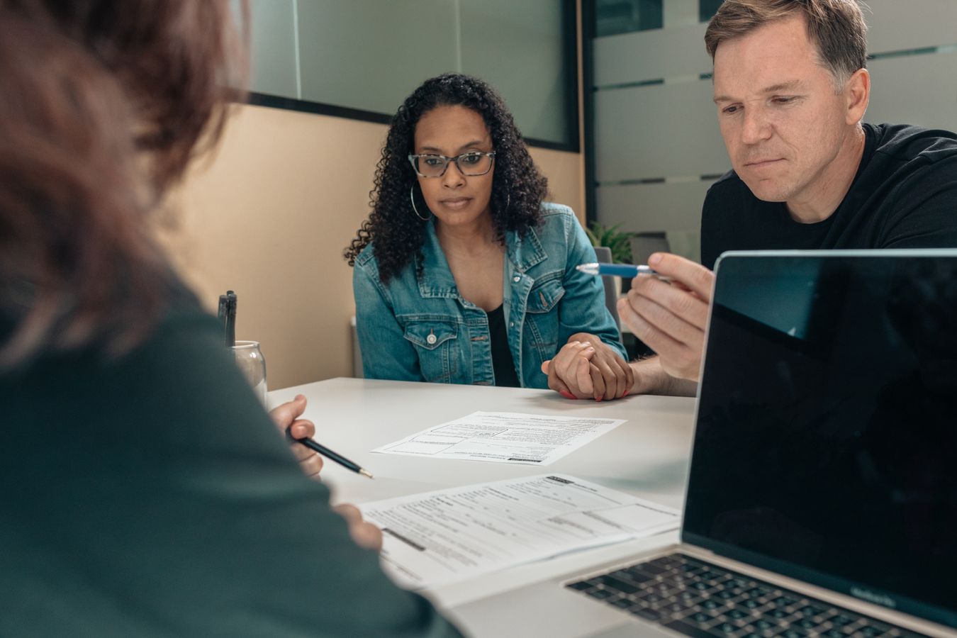 Couple reviewing retirement and healthcare decisions with an advisor