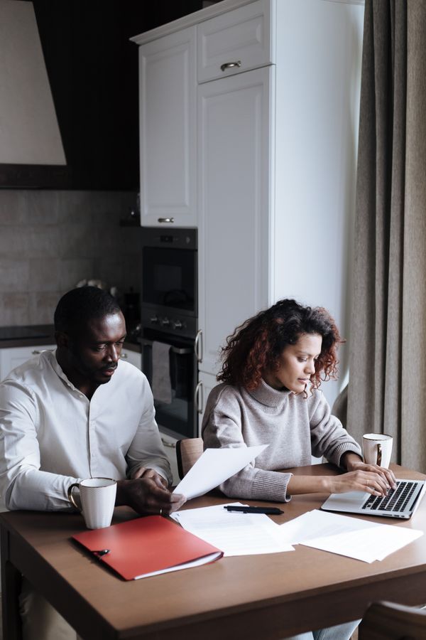 Couple reviewing important documents together in their home