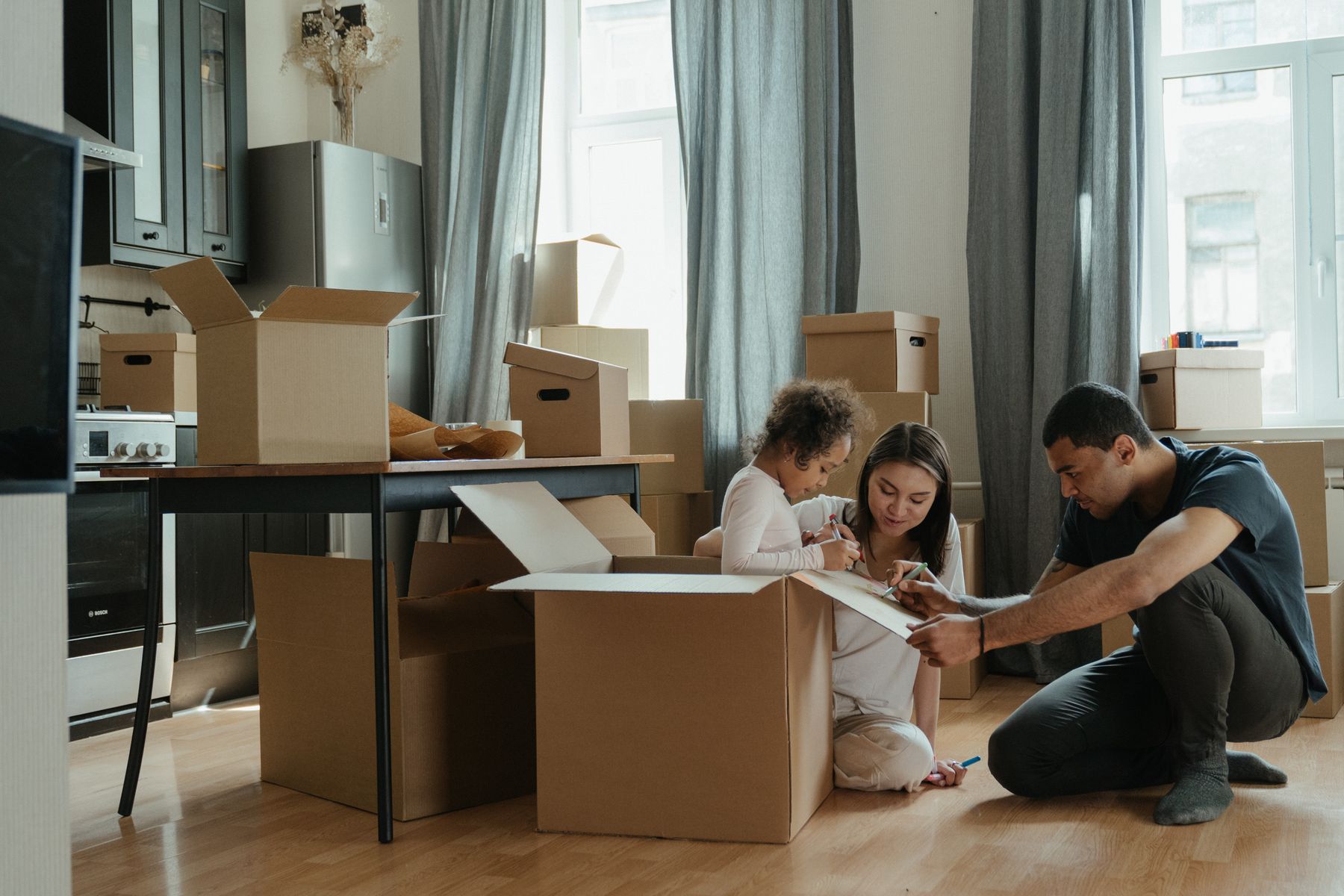 Family unpacking together in a new home